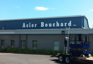 Lettres découpés en alupanel 1/4" et installé avec tiges et silicone | Utilisation : Enseigne dans un parc industriel